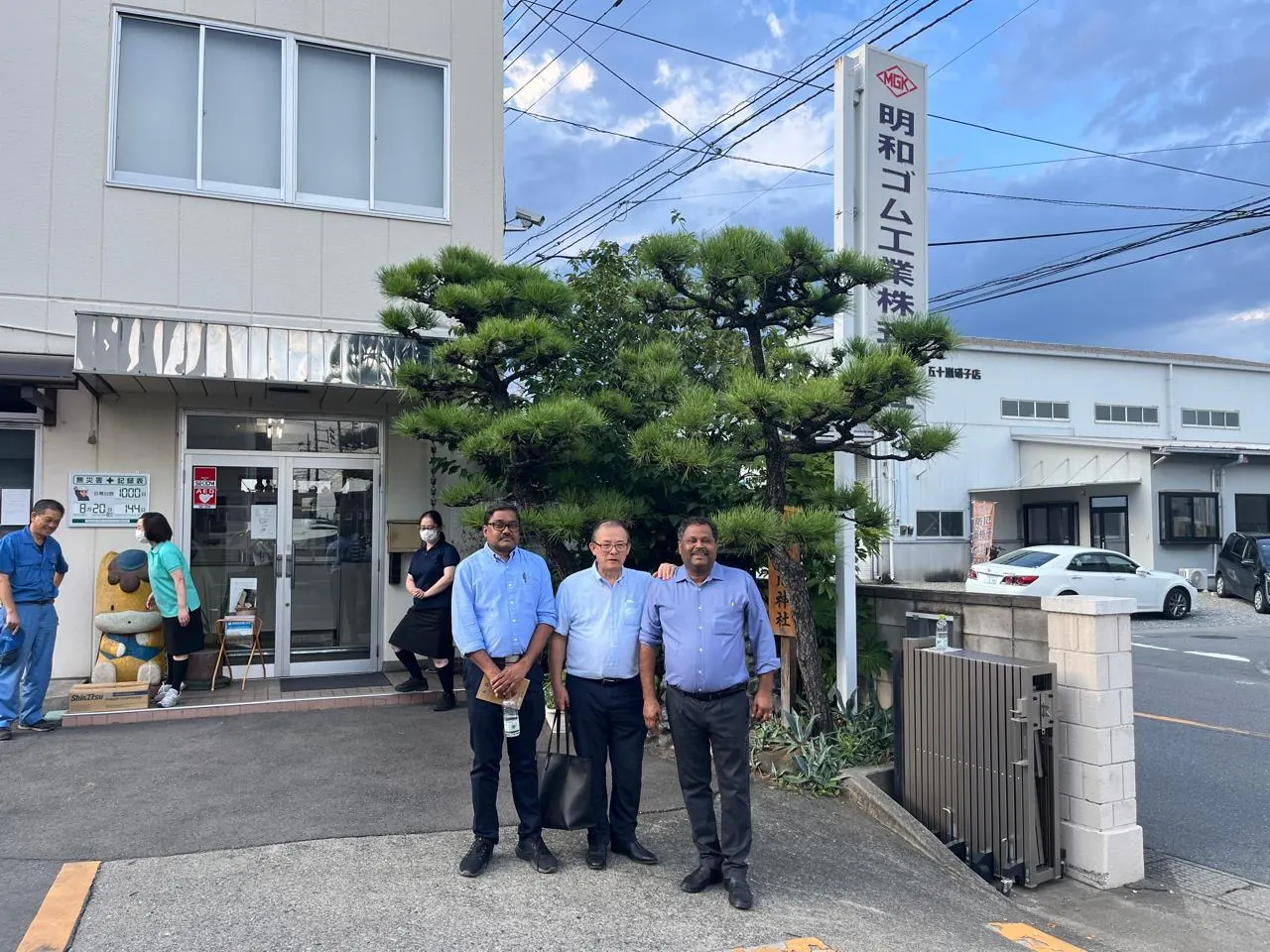 Group photograph outside the Meiwa plant in Japan during technical training